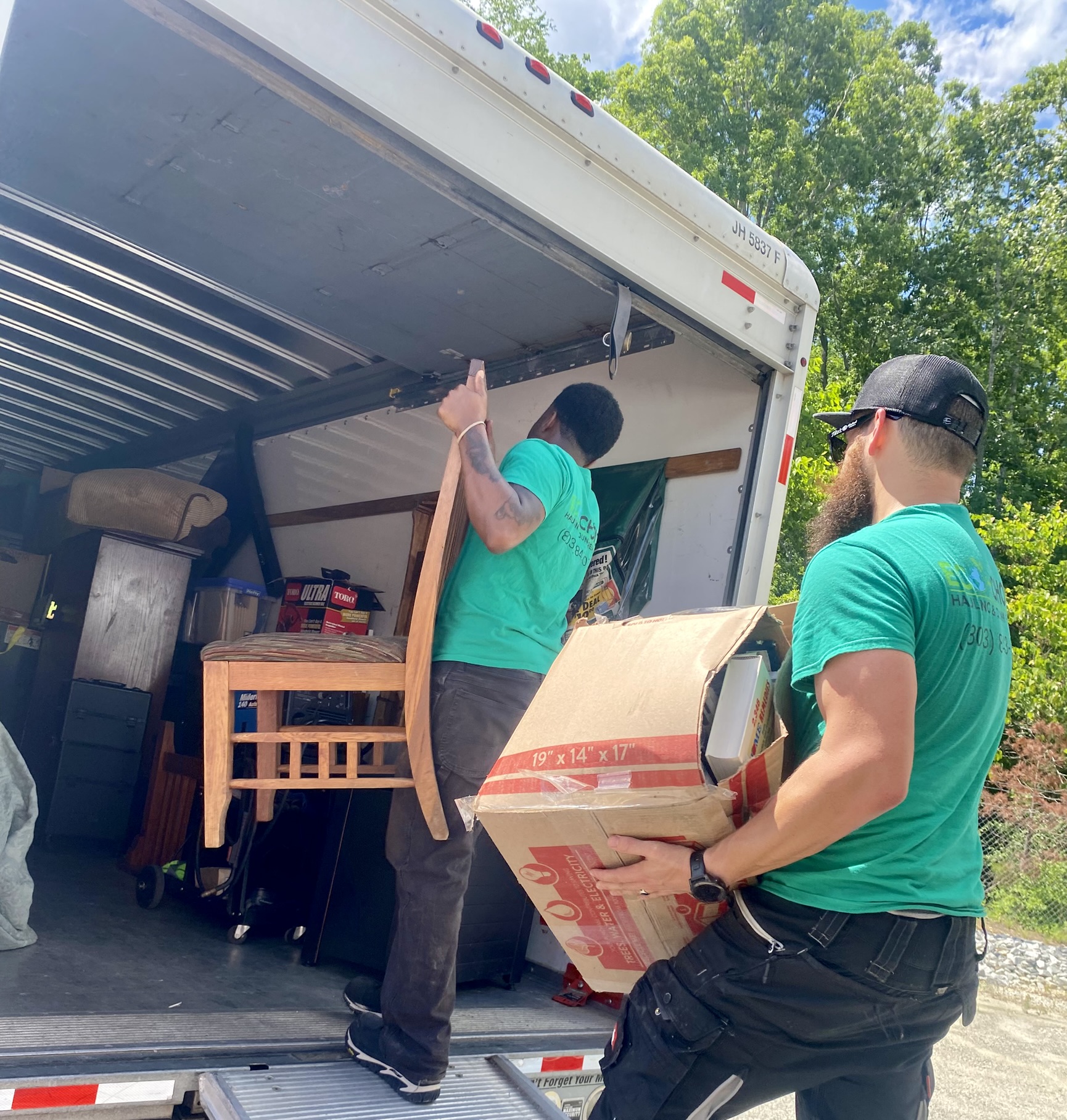 a group of men unloading a moving truck